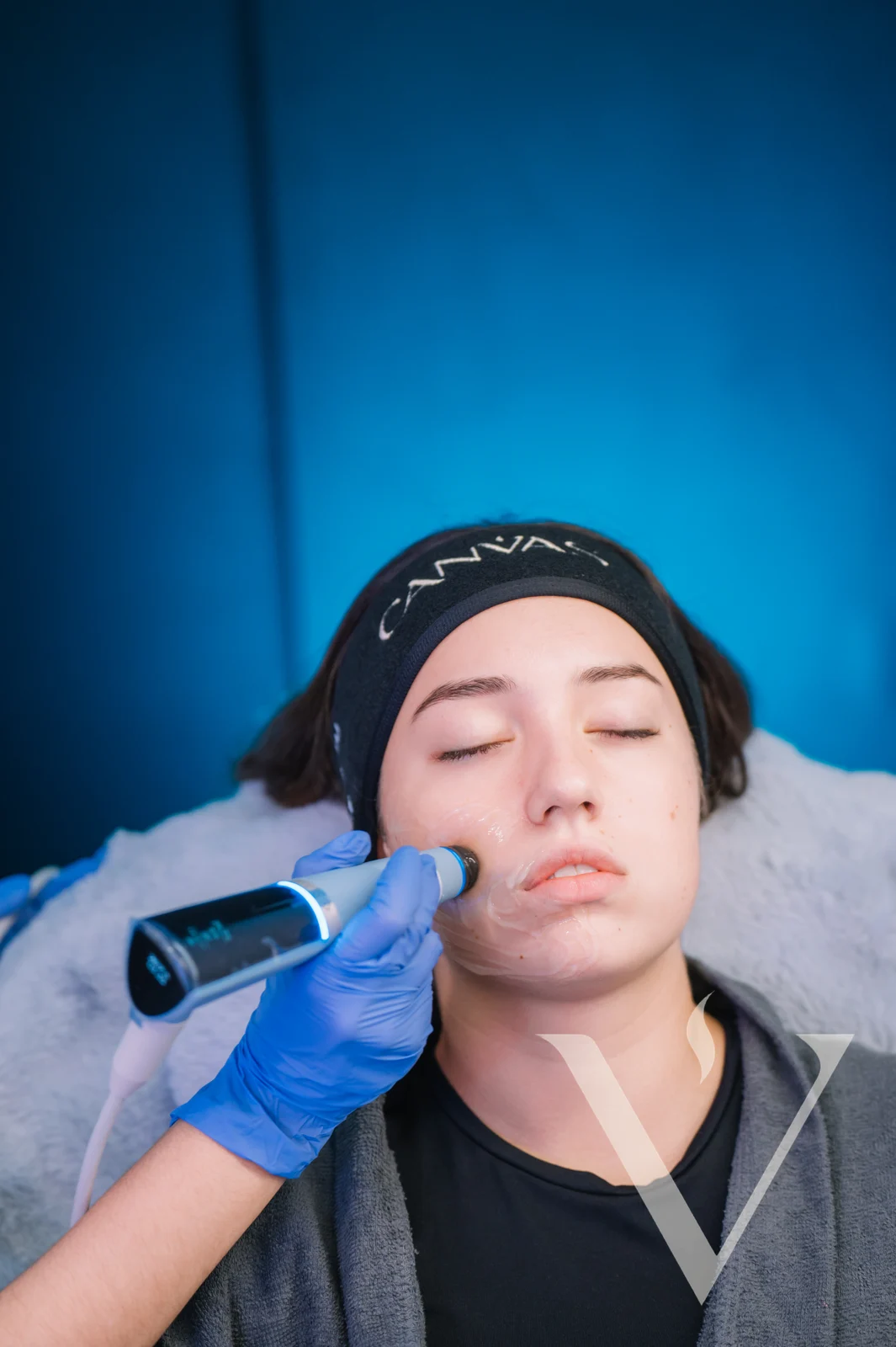 Close-up of an ultrasound treatment device on a client's cheek at CANVAS Medical Clinic, Penang