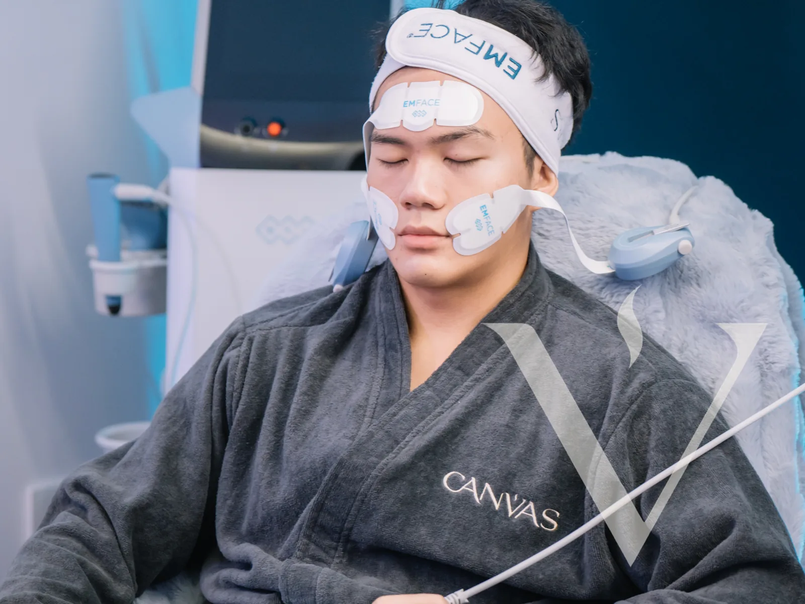 A client in a CANVAS robe receiving EMFACE treatment at CANVAS Medical Clinic, Penang